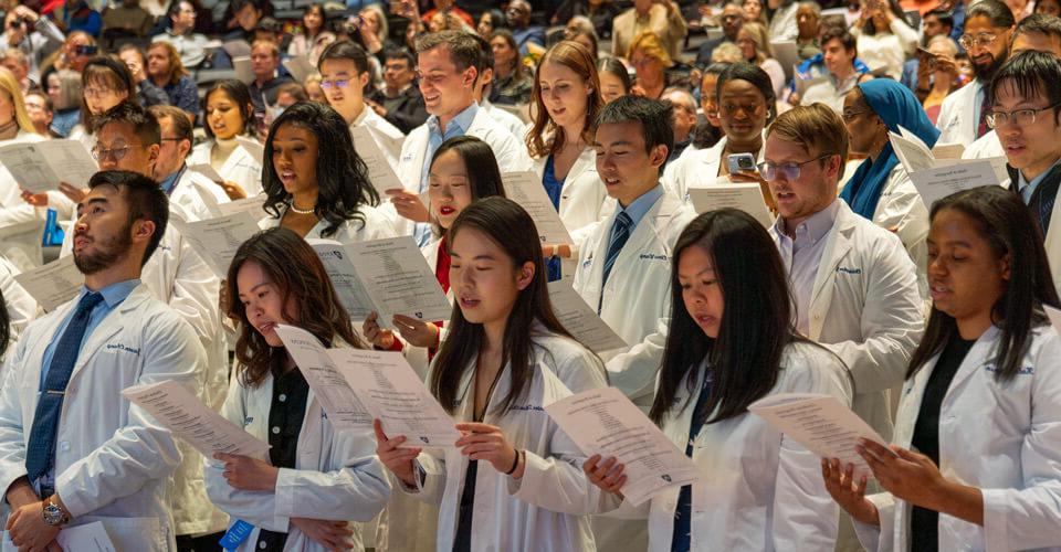 White coats in audience stand